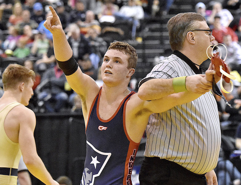 Independence's Haegan Harvey points to fans and family in the stands after winning the 152-pound state championship match by Brad Davis of The Register-Herald
