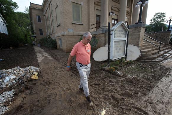 The Rev. J.F. Lacaria surveys flood damage at Clendenin United Methodist Church by Mike DuBose, United Methodist Communications 6-28-2016