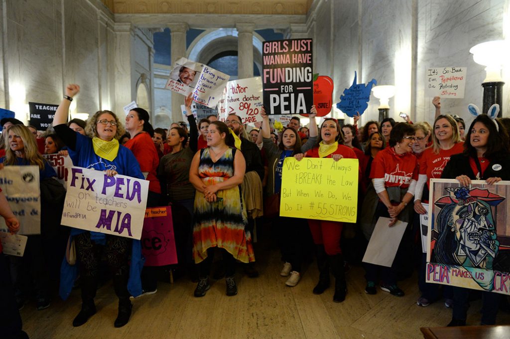 In what’s becoming a familiar sight, West Virginia teachers stood outside the Senate chamber in the state Capitol on Thursday, chanting for higher pay and better benefits. Kenny Kemp | Gazette-Mail