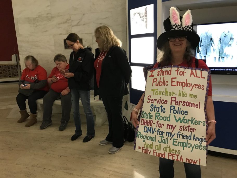 Mary Ross, a teacher from Webster County High School, is ready with her hat and her sign. Photo courtesy Brad McElhinny.