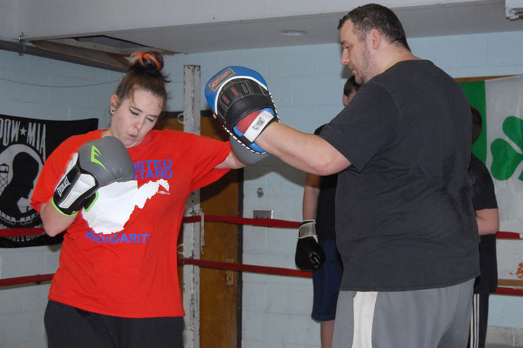 Megan Emmett of St. Albans spars with Brad Mullins at the Elk River Boxing Club's new location in Elkview by Ben Calwell