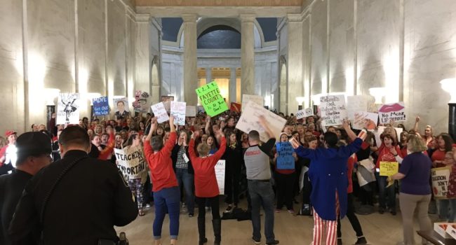 Teachers hold signs and chant in front of the state Senate chamber by Brad McElhinny of MetroNews